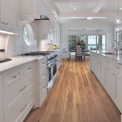 charming wood look kitchen flooring with white cabinets